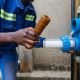Closeup of African plumber showing one dirty and one clean filters. Changing water filters.